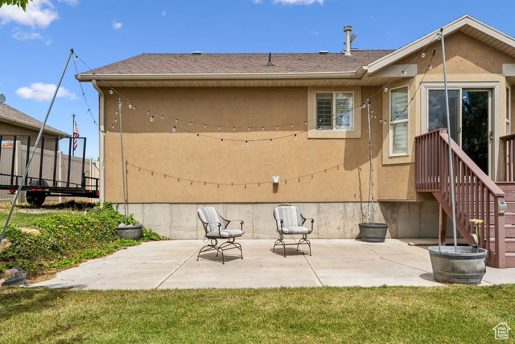 Rear view of property with a patio and stucco siding