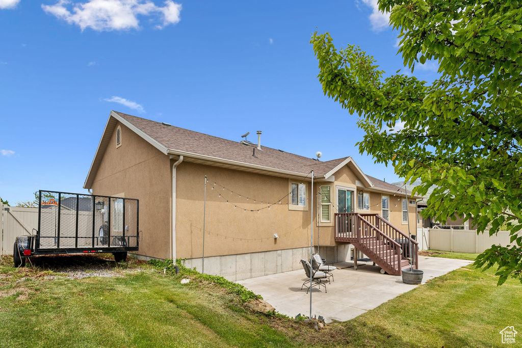Rear view of house featuring a patio and stucco siding