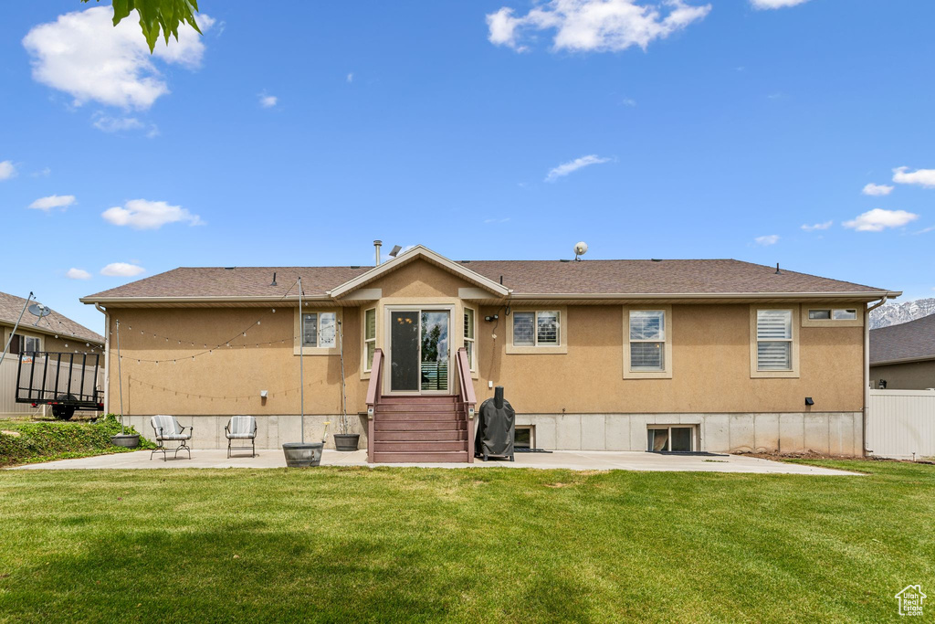 Rear view of property featuring a patio and stucco siding