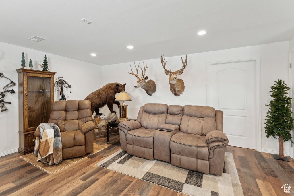 Living area with wood finished floors, recessed lighting, and baseboards