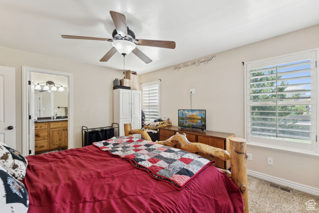 Bedroom with multiple windows, carpet, baseboards, and a ceiling fan