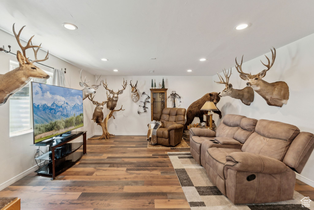 Living area with recessed lighting, wood finished floors, and baseboards