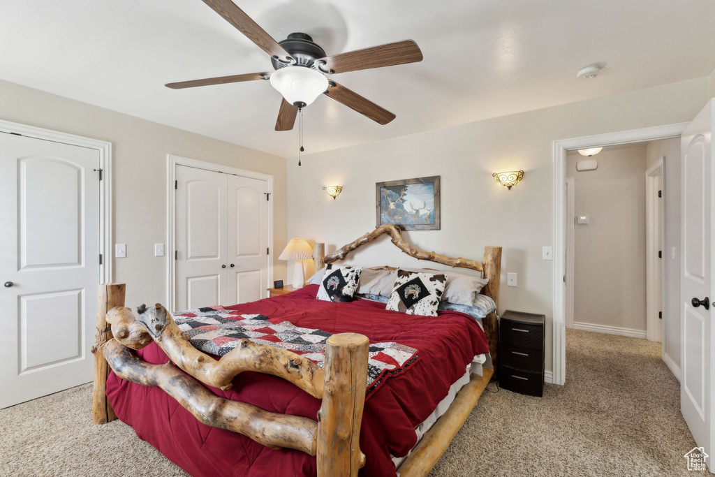 Carpeted bedroom featuring a closet, a ceiling fan, and baseboards