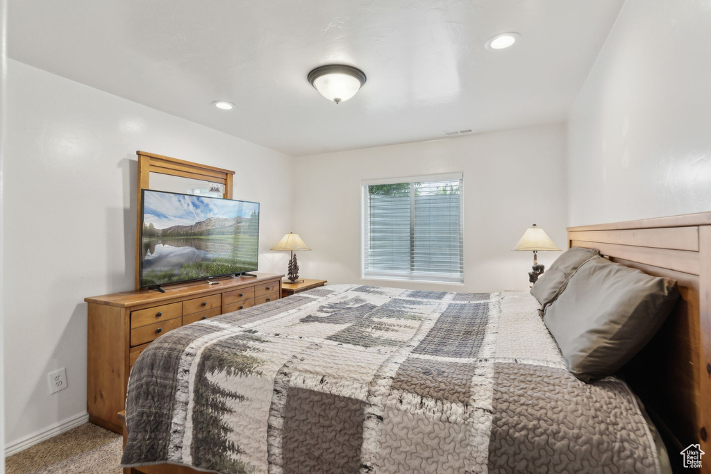 Bedroom with baseboards, recessed lighting, and light colored carpet