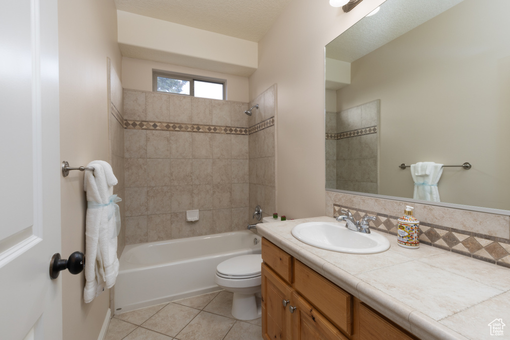 Full bath with vanity, tile patterned flooring, bathtub / shower combination, and toilet