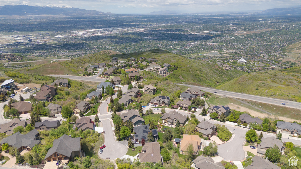 Aerial view of property and surrounding area with nearby suburban area