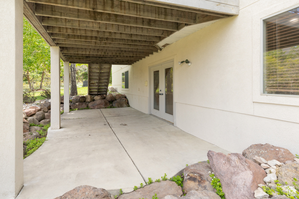 View of patio / terrace featuring french doors and stairs