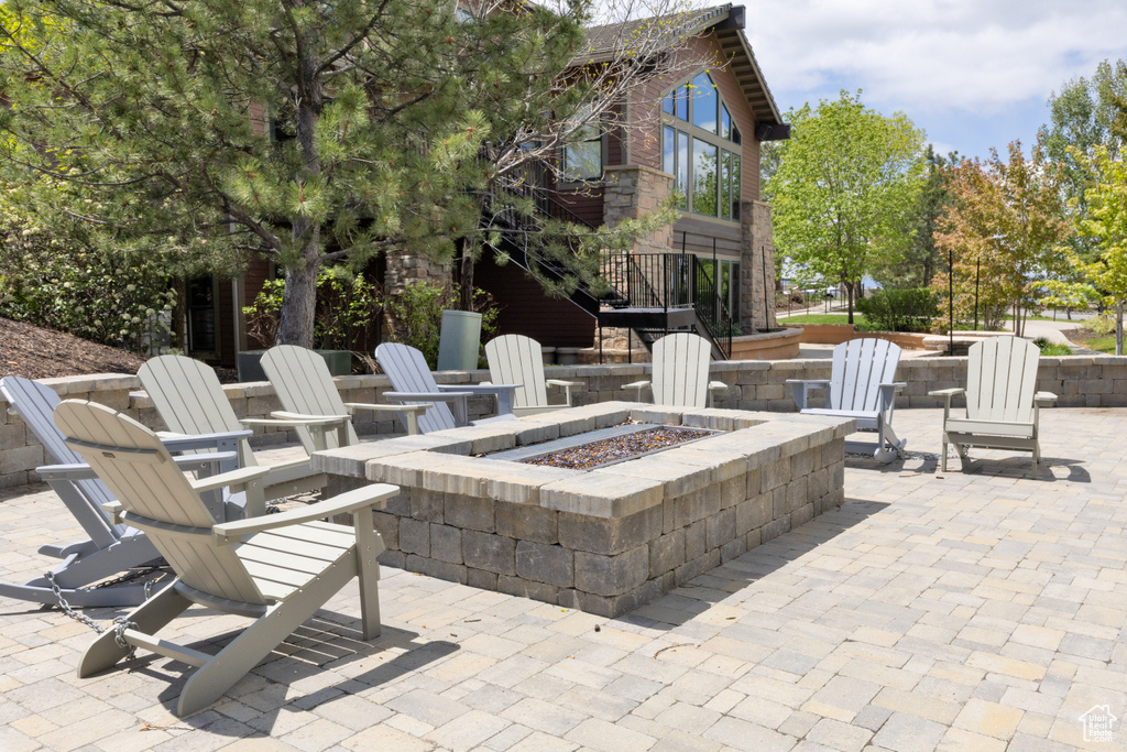View of patio / terrace with an outdoor fire pit and stairs