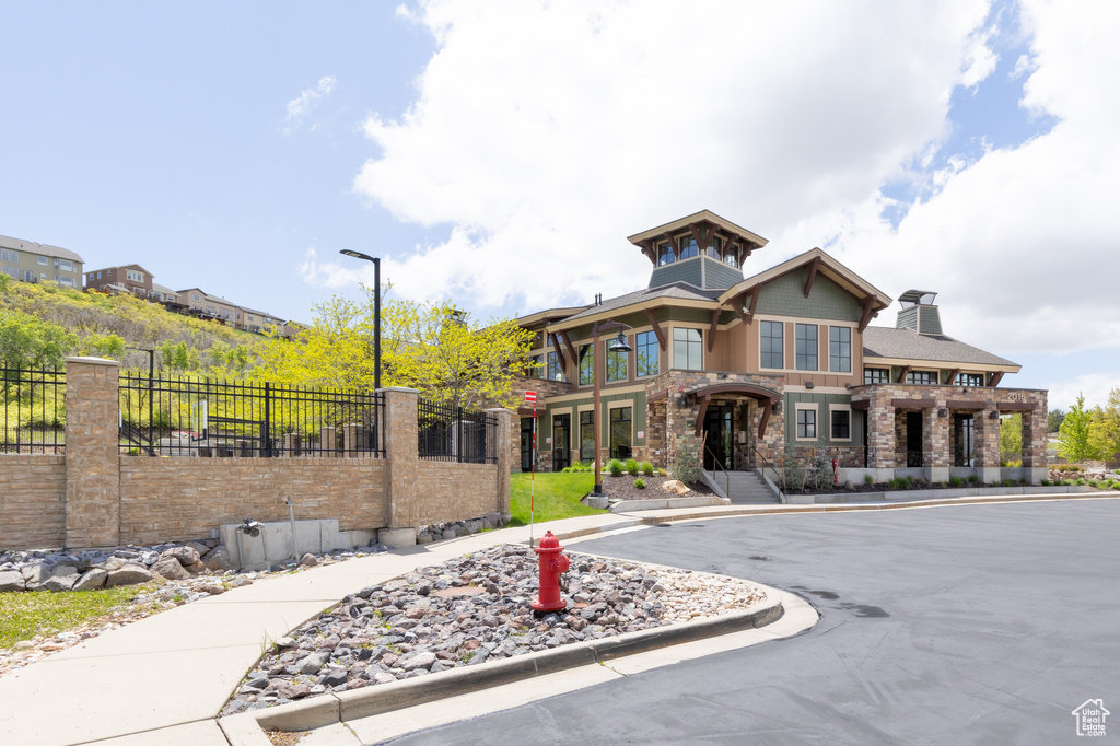 View of front of property featuring stone siding and a chimney
