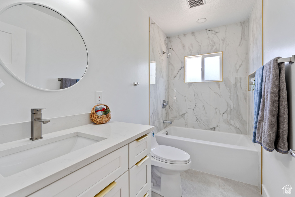 Full bath with vanity, shower / tub combination, toilet, and tile patterned floors