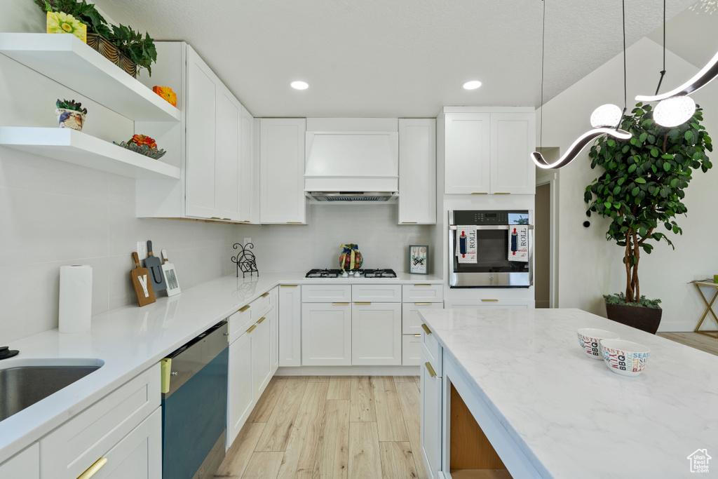 Kitchen featuring oven, dishwashing machine, recessed lighting, white gas cooktop, and light wood finished floors