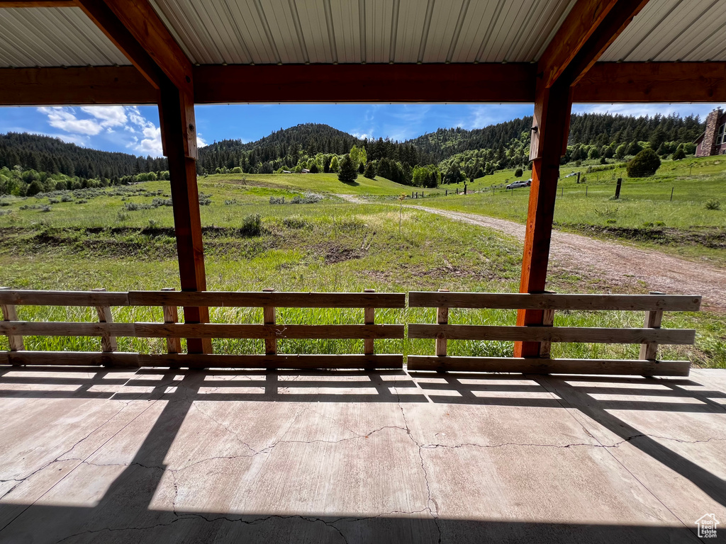 Deck with a view of trees and a rural view