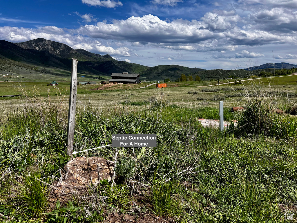 View of mountain backdrop featuring rural landscape and agricultural land