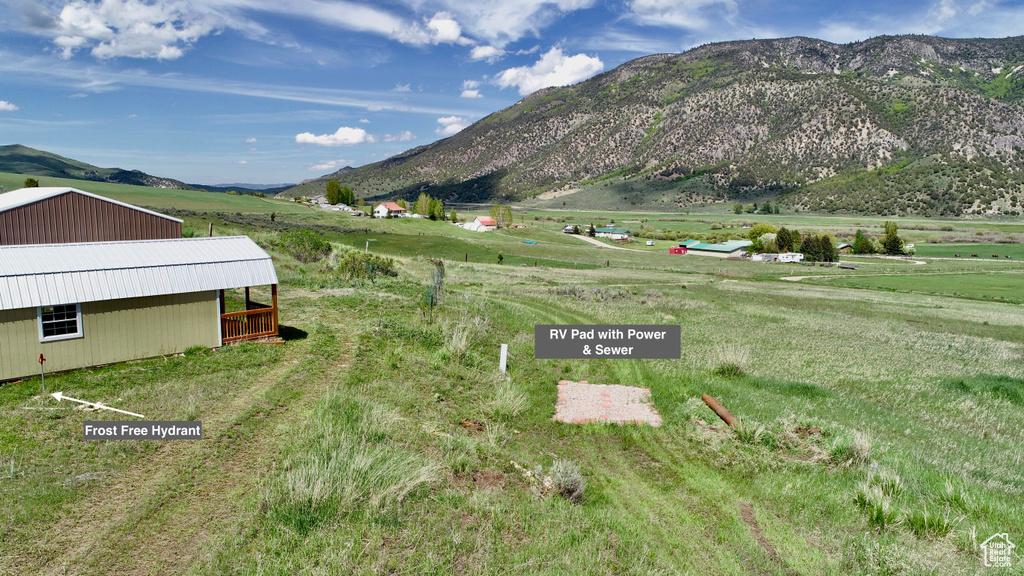 View of mountain backdrop featuring rural landscape