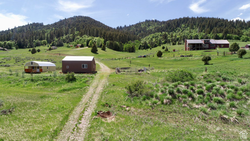 View of mountain backdrop featuring a heavily wooded area and rural landscape