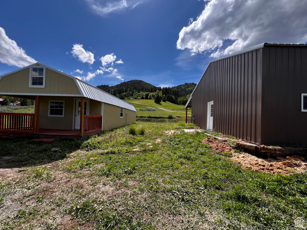 View of home's exterior with a deck with mountain view