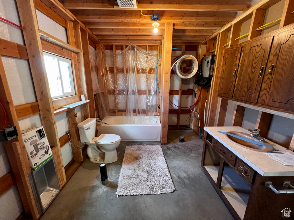 Full bath with toilet, vanity, shower / bath combination with curtain, and concrete flooring