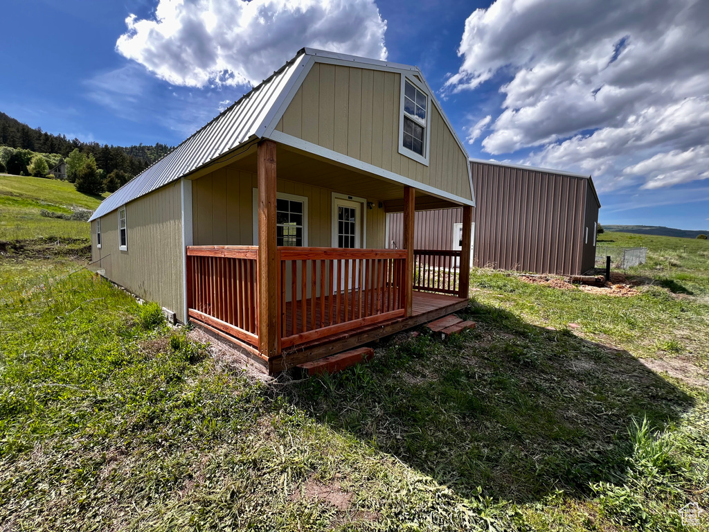Rear view of property with metal roof