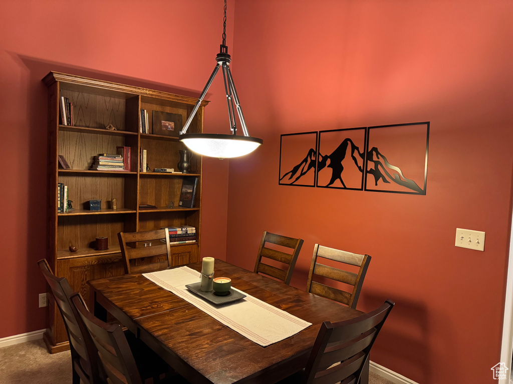 Dining area with baseboards and carpet