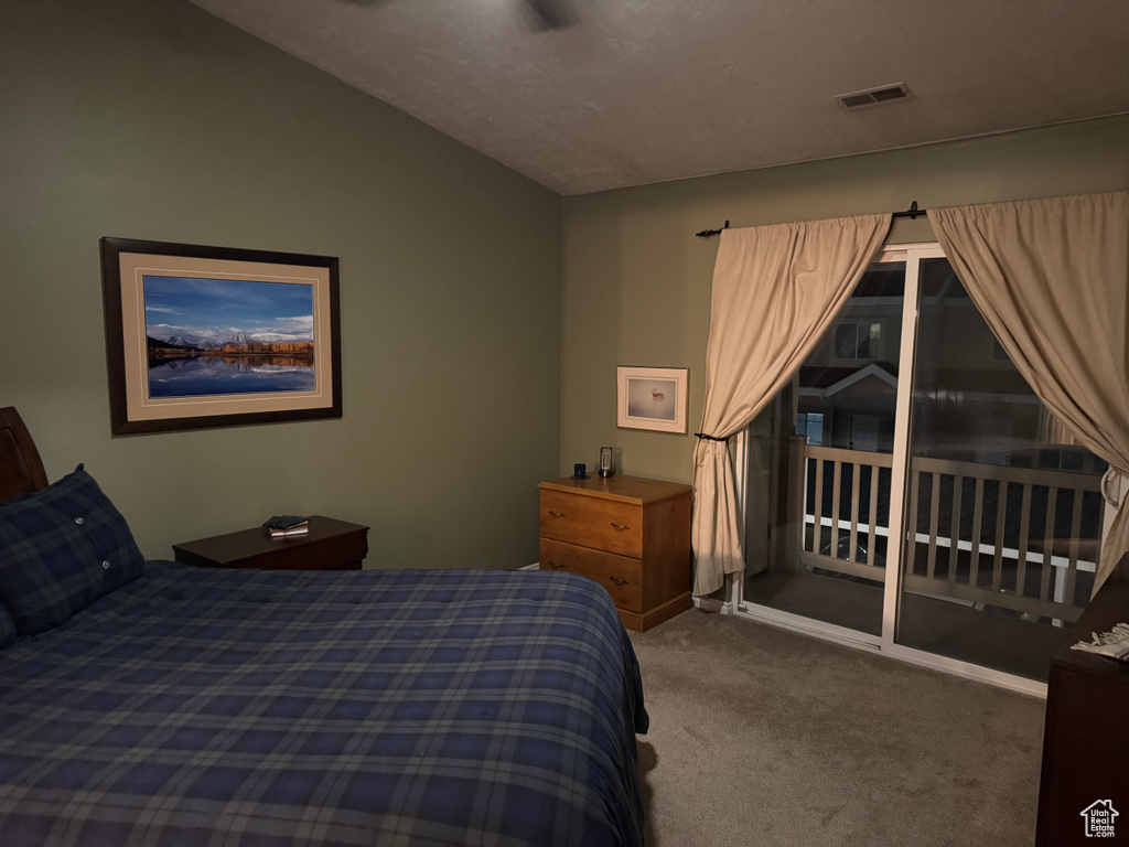 Bedroom with carpet flooring and vaulted ceiling