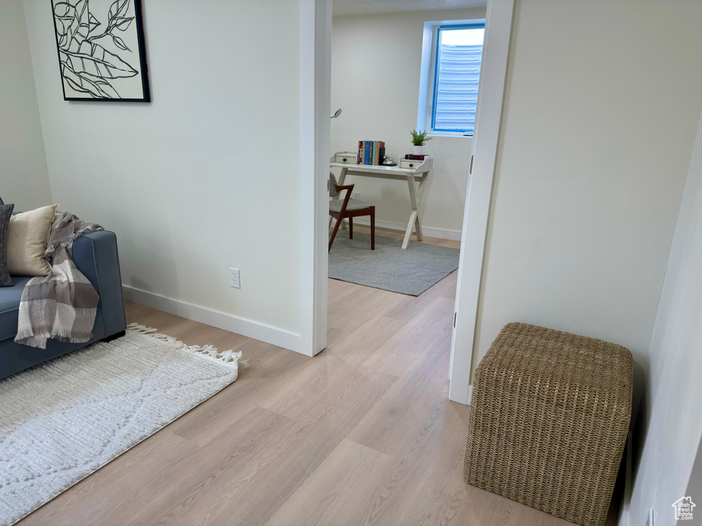 Sitting room with wood finished floors and baseboards
