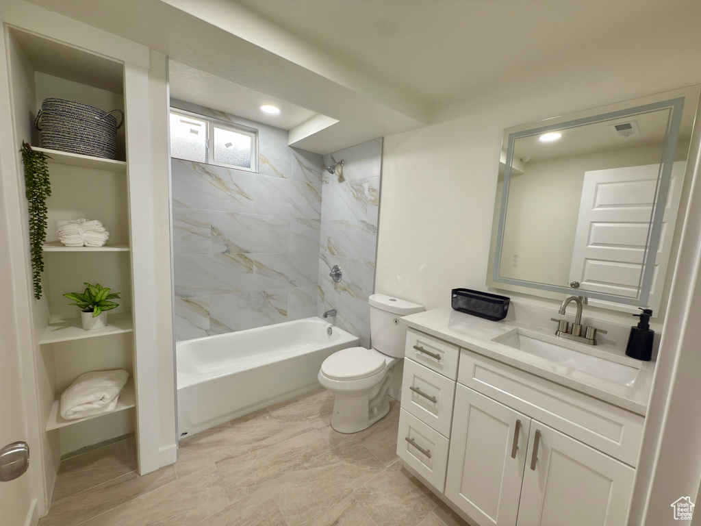Full bath featuring toilet, vanity, and shower / bath combination