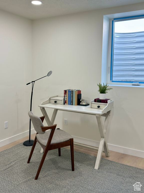 Office with wood finished floors and baseboards