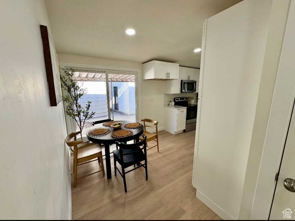 Dining area with recessed lighting, light wood-style flooring, and baseboards
