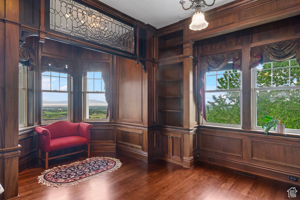 Living area with dark wood-style flooring and wooden walls