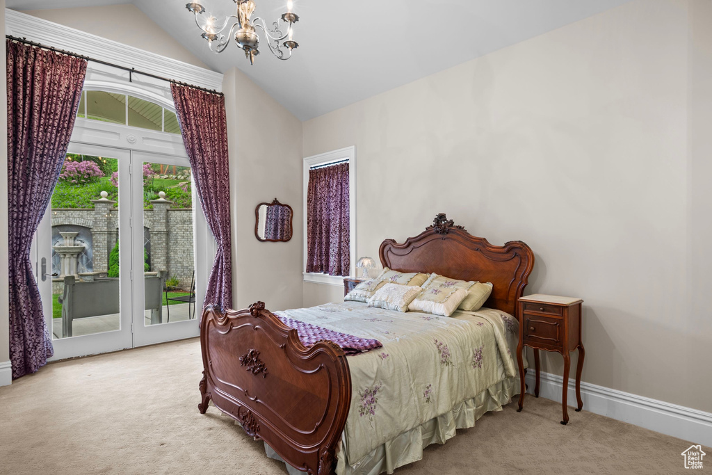 Bedroom with carpet flooring, a chandelier, access to exterior, lofted ceiling, and baseboards