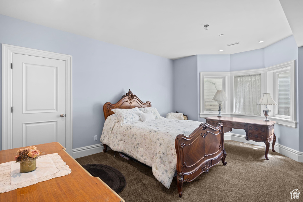 Bedroom with carpet flooring and baseboards