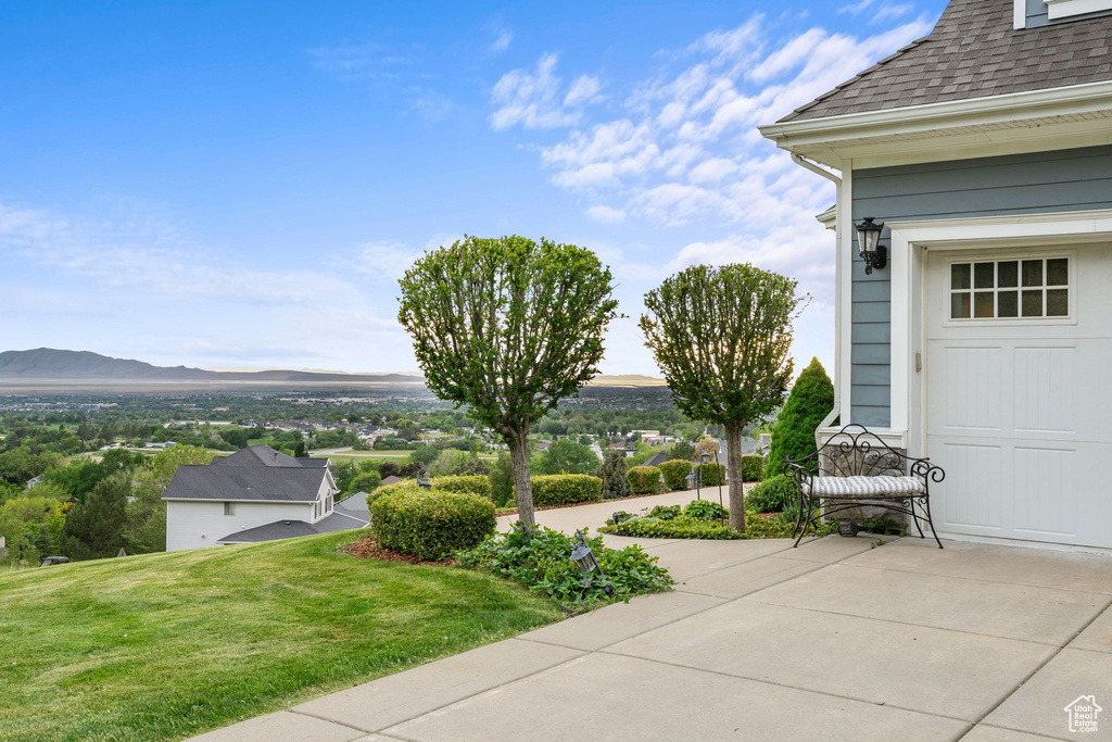 View of grassy yard with a mountain view