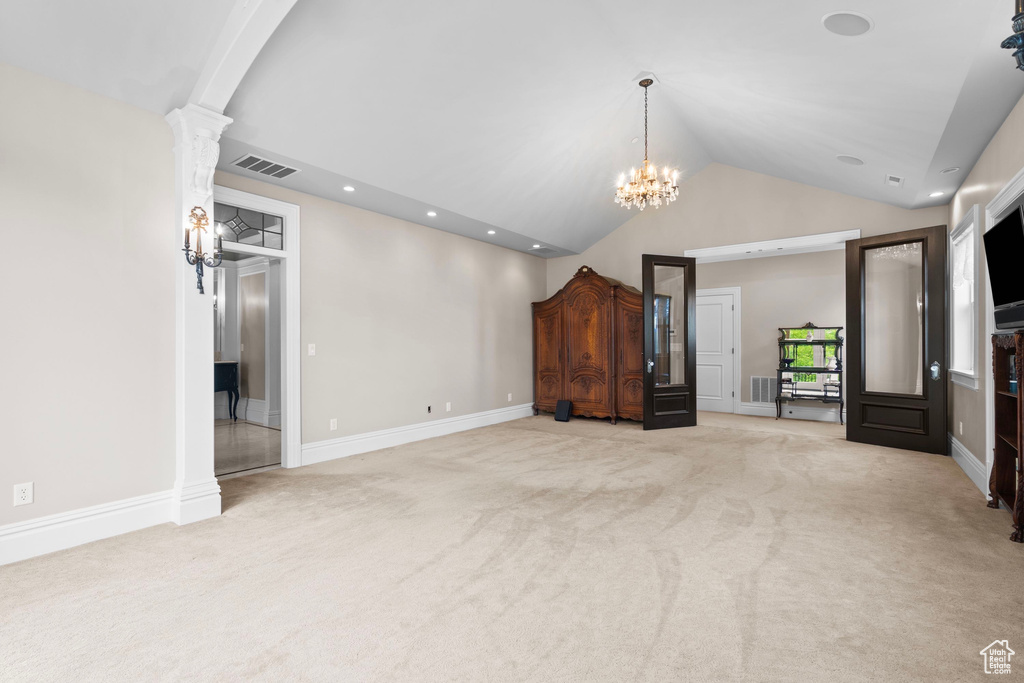 Unfurnished living room with light carpet, vaulted ceiling, a chandelier, recessed lighting, and baseboards