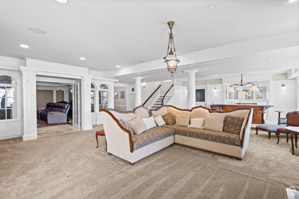 Living room with light colored carpet, ornamental molding, and recessed lighting