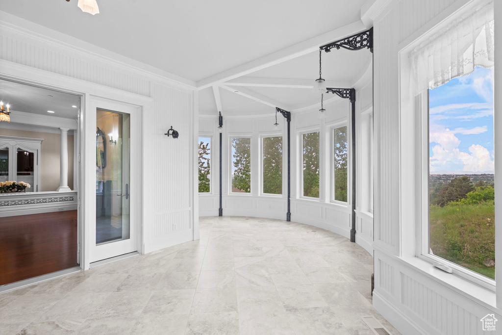 Unfurnished sunroom with healthy amount of natural light