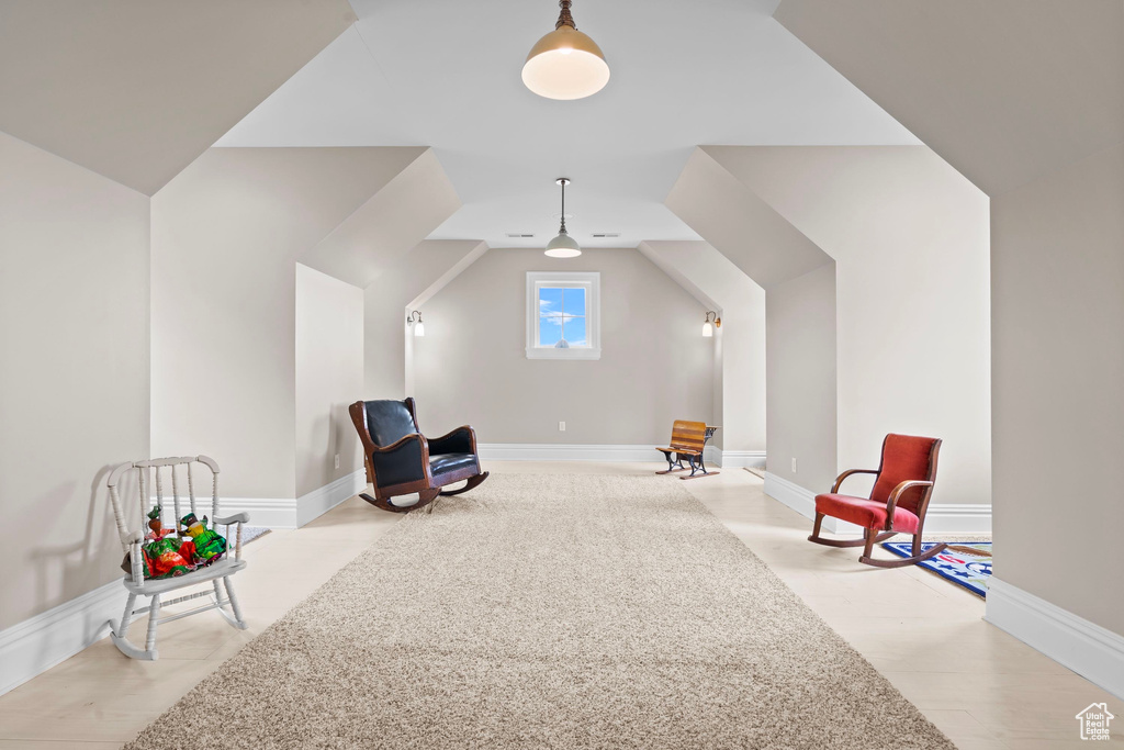 Unfurnished room with baseboards and lofted ceiling