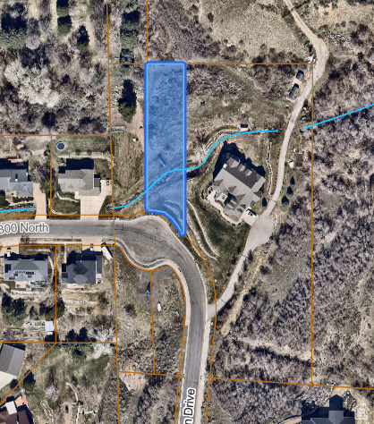 Aerial map of property and surrounding area featuring property boundaries highlighted