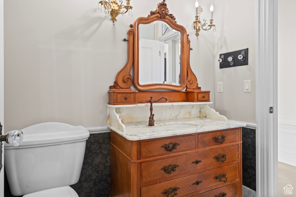 Half bathroom featuring toilet and vanity