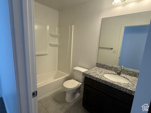 Bathroom featuring tile patterned floors, toilet, and vanity