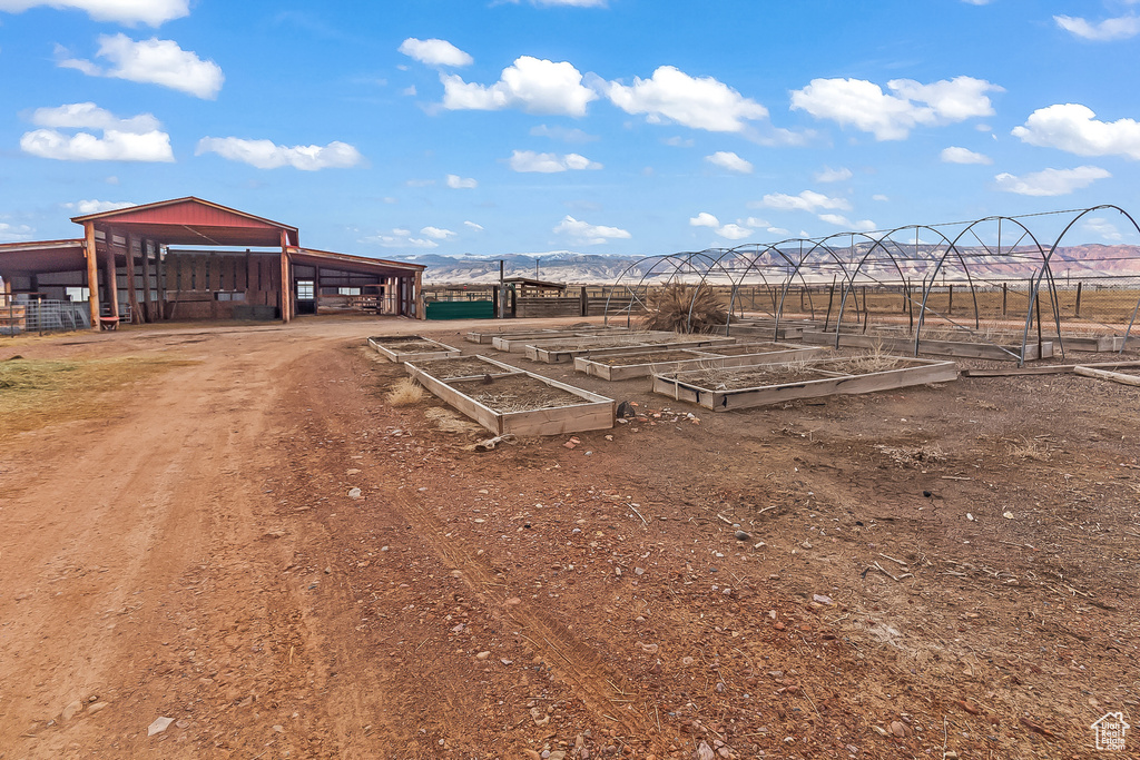 View of yard featuring a vegetable garden and a mountain view