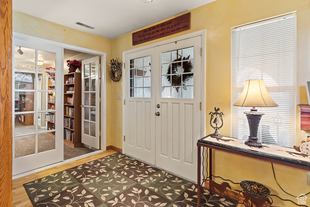 Foyer entrance with wood finished floors and french doors