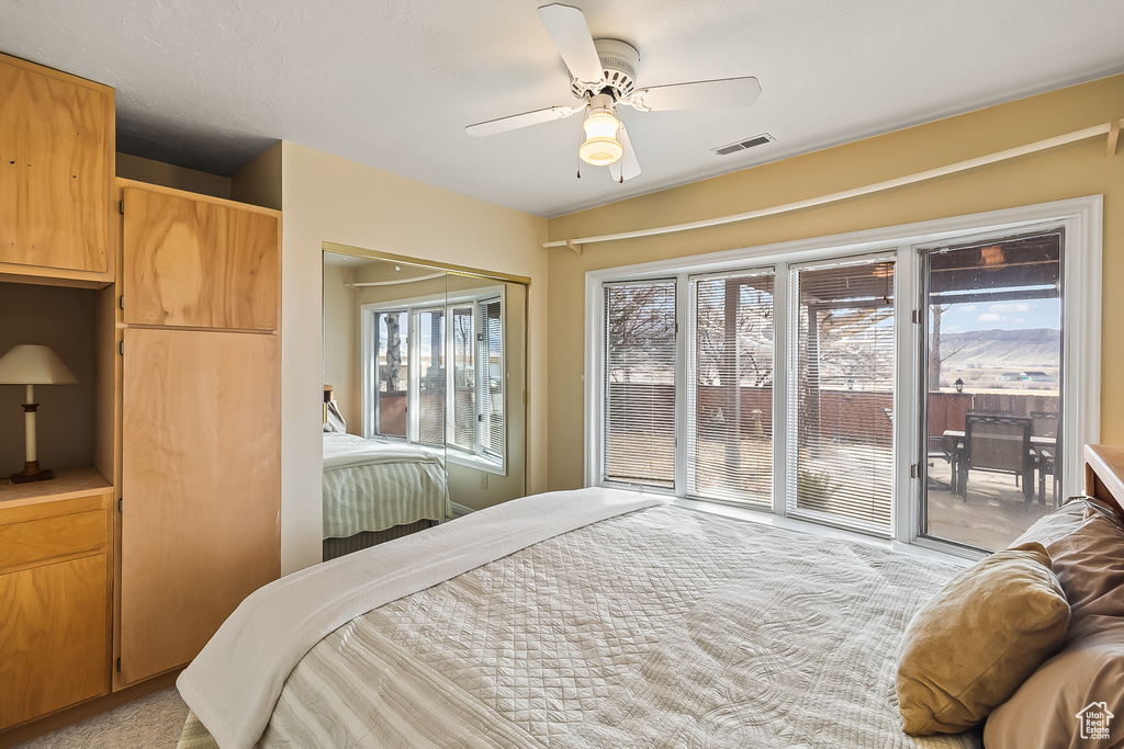 Bedroom featuring access to outside and ceiling fan