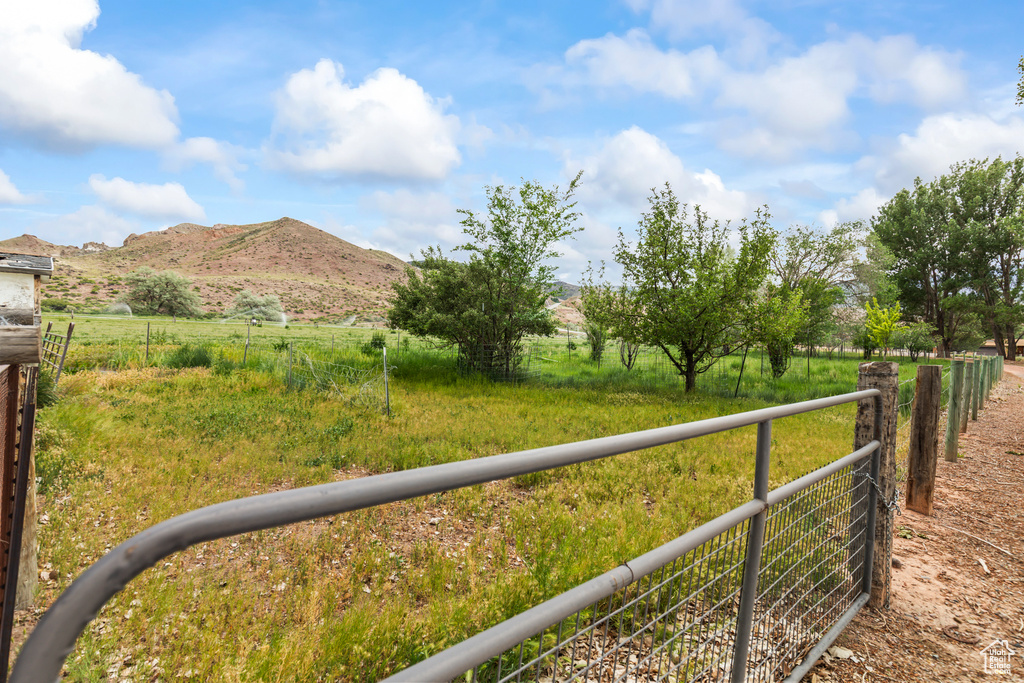 View of yard featuring a rural view and a mountain view