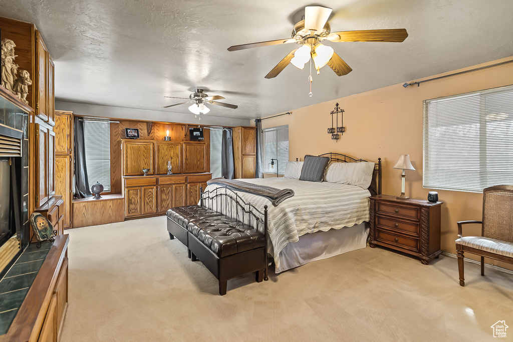 Bedroom featuring light colored carpet and a ceiling fan