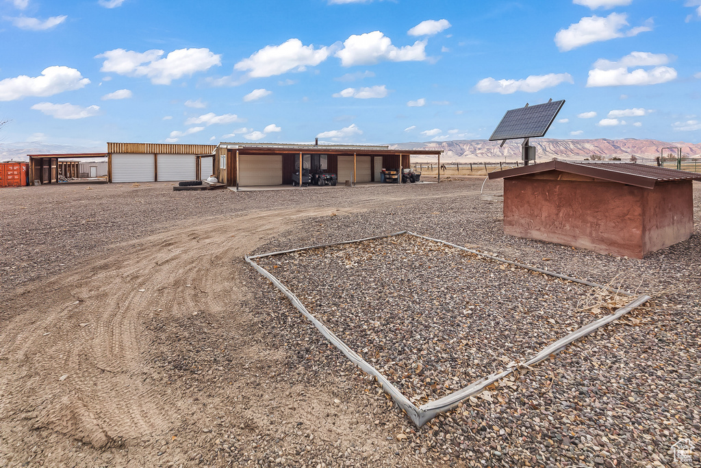 View of outbuilding with dirt driveway