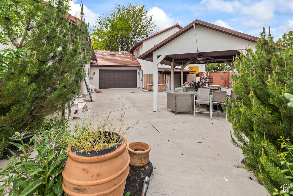 View of patio / terrace with a garage and outdoor dining area