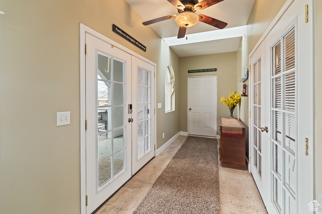 Doorway to outside with french doors, ceiling fan, and baseboards
