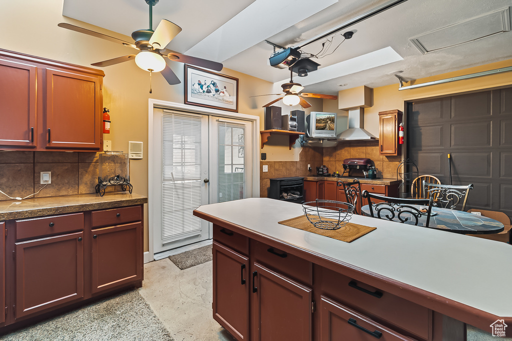 Kitchen with ceiling fan, wall chimney range hood, tasteful backsplash, and open shelves