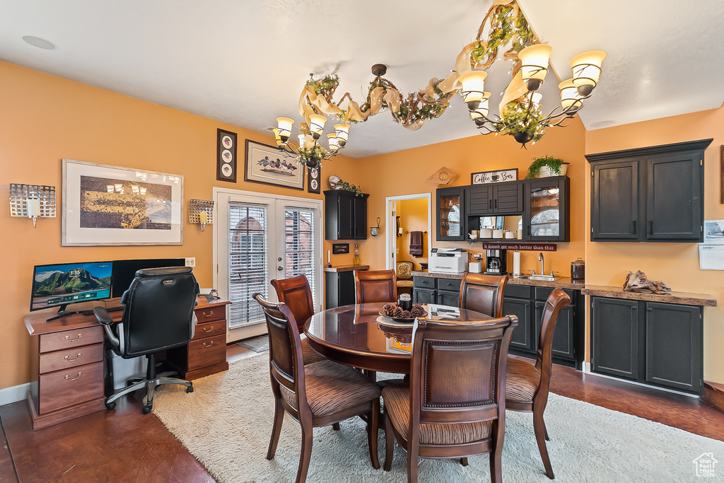 Dining area with a chandelier, french doors, an office area, and baseboards