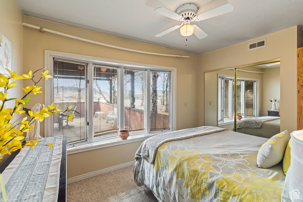 Carpeted bedroom featuring baseboards, a closet, and ceiling fan